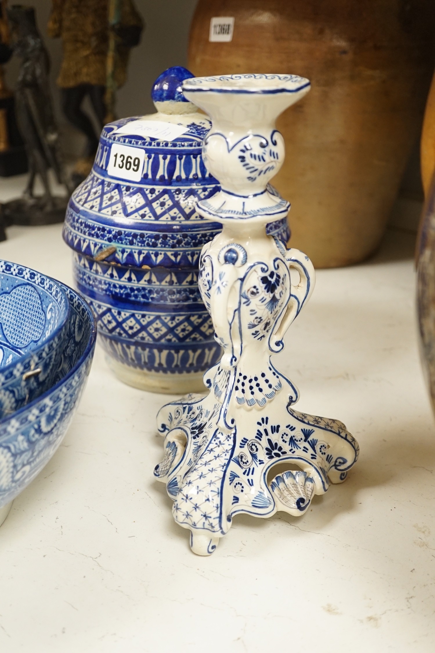 A pair of Delft blue and white candlesticks together with an 18th century Delft bowl, a Moroccan pottery jar with cover, and two pearlware bowls
